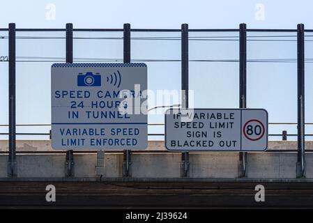 A speed camera and variable speed limit sign on the M1 motorway in Sydney Stock Photo