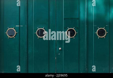 Green old wooden painted door with windows. Grunge texture for background. Stock Photo