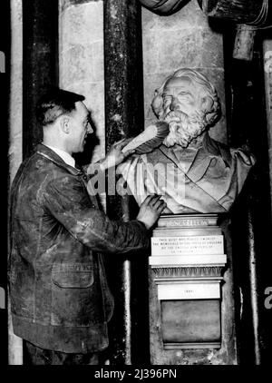 Washing Days For Poets' Corner Of Anbey -- The bust of Longfellow, one of the many of famous poets, now being cleaned at Westminster Abbey. That famous corner of Westminster Abbey trancept where Chaucer, Tennyson, Browning and other famous English poets are buried is 'Closed for repairs'. It is now covered with scaffolding in order that the ancient vault and walls, which are within a few years of their seven hundredth birthday, may be cleaned and the real beauty revealed. All the stone is being carefully brushed and washed and it is probable that a coating of limewash will be applied as a Stock Photo