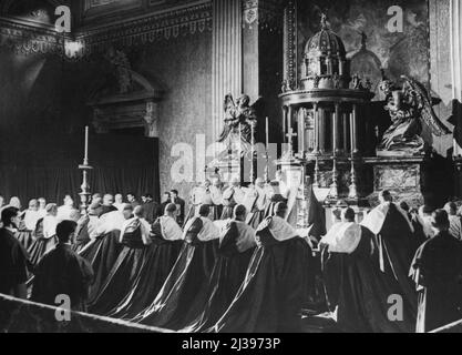 New Cardinals Take Oath Of Fealty - Kneeling before the altar in the chapel of the Holy Trinity, 18 St Peter's. The 31 new cardinals take the Oath of ***** before entering the main part of the Basilioa to receive their red hats from Pope Pius XII. February 23, 1946. (Photo by Associated Press Photo). Stock Photo