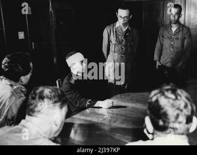 Tells Hiroshima Story -- Hirokuni Dazai, Leader of the Hiroshima ***** relates his version of the atomic bombing of Hiroshima. He arrived in the devastated city forty minutes after the bomb exploded - he was injured by falling timber while doing rescue work. Standing at Dazai's left is an interpreter. September 13, 1945. (Photo by Associated Press Photo). Stock Photo