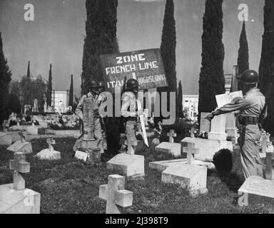 Marking New Italic-Yugoslav Boundary -- Soldiers place a marker in a cemetery on the outskirts of Gorizia, divided by the French Line, September 10. At this point, near Gorizia, Venezia Giulia, West of the 'Morgan Line' that the Anglo-American and Yugoslav occupation areas of the once completely Italian province of Venezia Giulia, were divided. Graves in foreground are thoge of Italian soldiers who died in World War II. Soldiers in picture are from 350th Infantry Regiment, U.S. 88th Division. When instruments of ratification of the Italian Peace Treaty are deposited in Paris, September 15, Stock Photo