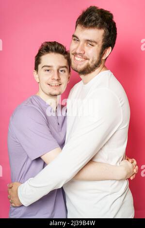 Young gay couple standing together over isolated ping background Stock Photo