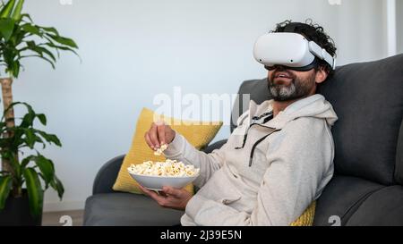 Portrait of man wearing casual white sweatshirt sitting on divan