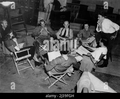 WALTER BRENNAN BARBARA STANWYCK GARY COOPER JAMES GLEASON and Director FRANK CAPRA on set candid during filming of MEET JOHN DOE 1941 director FRANK CAPRA based on story by Richard Connell and Robert Presnell screenplay Robert Riskin Frank Capra Productions / Warner Bros. Stock Photo