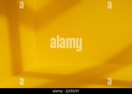 Yellow room corner with crossing windows shadows. Minimalistic space concept Stock Photo
