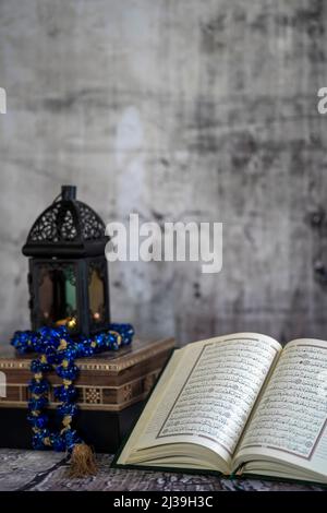 Ramadan lantern and lit up and the Holy Quran book. Stock Photo