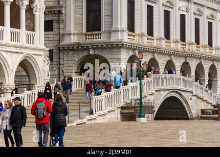 VENICE, ITALY - MARCH 27 2022: Crowds of tourists stopping at the Bridge of Sighs at St Marks Square, Venice Stock Photo
