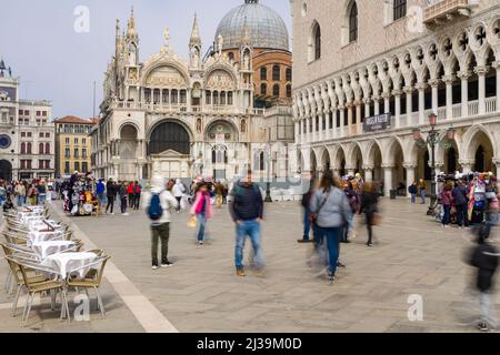 VENICE, ITALY - MARCH 27 2022: Crowds of tourists near the Doge's Palace and Basilica in St Mark's Square in the city of Venice Stock Photo