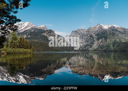 A mountain reflection on Taggart Lake in Grand Teton National Park Stock Photo
