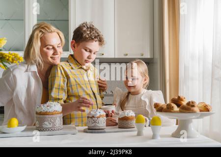 Mom and kids cook together in the kitchen. Stock Photo