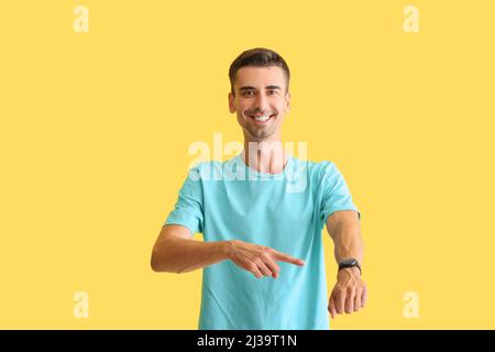 Handsome man with smartwatch on color background Stock Photo