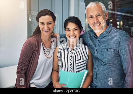 Theres no one better than us. Cropped portrait of three colleagues standing in the office. Stock Photo