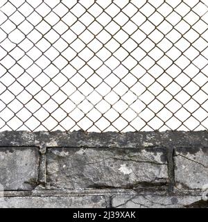 Rusty wire mesh fence, dark white grey fine brick wall texture background, vertical isolated old aged weathered rusted iron perimeter security concept Stock Photo