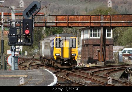 Northern Trains class 156 super sprinter dmu, unit number 156465, passing signal box and approaching Carnforth station on Wednesday 6th April 2022. Stock Photo