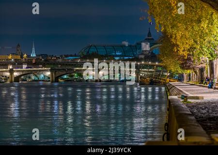 Peoples on Docks in Paris Touristic Center With Seine River and Bridge