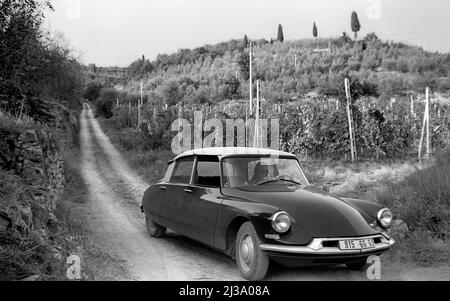 Classic Citroen car on country road in Tuscan region of Italy. Stock Photo