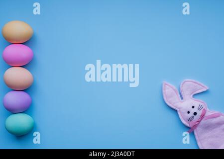Happy Easter concept. Holiday preparation. Easter eggs and bunny isolated on trendy pastel blue background. simple minimalism flat lay top view copy s Stock Photo