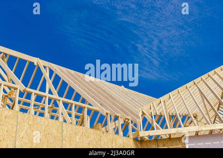 New home construction of construction roof timbers the framing in newly built Stock Photo