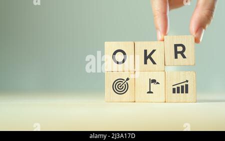 OKR, Objectives And Key Results Symbol. Businessman Turns Cubes With ...