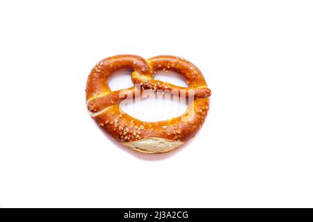 Freshly baked pretzel close-up, isolated on a white background. Stock Photo