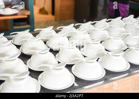 empty cup and spoon on the table, white cup bowl ready to serve for soup Stock Photo