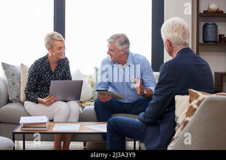 I told you hes the best at this. Shot of a group of businesspeople going through paperwork. Stock Photo