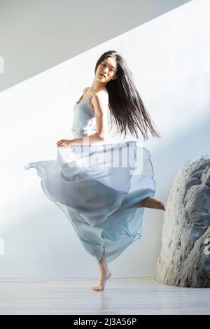 Creative pictures, fashionable female dancer whose train moves with her body - stock photo Stock Photo
