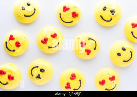 Top down view of several smiley face emoji merengue cookies. Stock Photo