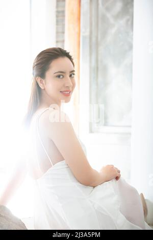 Beautiful young lady doing skin care in a modern upholstery environment - stock photo Stock Photo