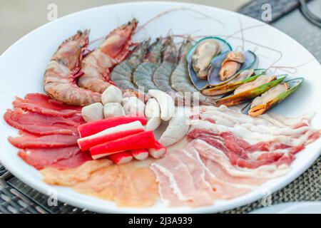 Assortment of fresh seafood, meat for cooking in grill or hot pot, asian food Stock Photo