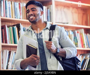 Get studying and go places. Shot of a young man studying in a library at university. Stock Photo