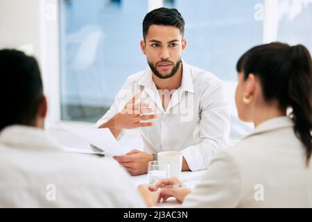 Having some business talk. Shot of businesspeople having a meeting in a boardroom at work. Stock Photo
