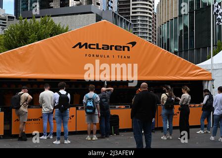 McLaren Formula 1 Team merchandise stall in Melbourne, with fans queueing to purchase team gear before the start of the Grand Prix weekend