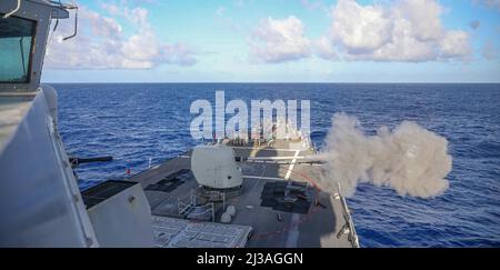 PHILIPPINE SEA (March 20, 2022) Arleigh Burke-class guided missile destroyer USS Higgins (DDG 76) fires at a simulated target. Higgins is assigned to Commander, Task Force (CTF) 71/Destroyer Squadron (DESRON) 15, the Navy’s largest forward-deployed DESRON and the U.S. 7th Fleet’s principal surface force. (U.S. Navy photo by Mass Communication Specialist 2nd Class Arthur Rosen) Stock Photo