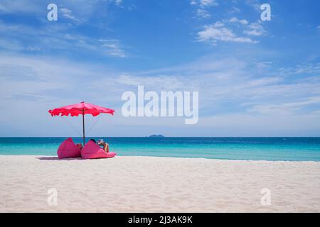 Pink parasol and  seat on the tropical beach, Vacation background.,Idyllic beach Stock Photo