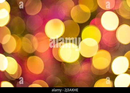 Yellow, red and orange glitter -- abstract festive elegant background with blurred bokeh lights. Defocused holiday lighting. Stock Photo