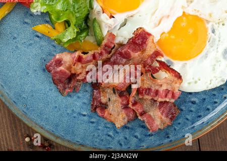 Closeup on fried bacon with eggs breakfast Stock Photo