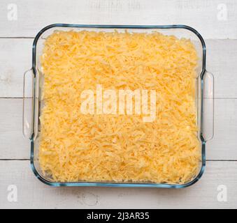 Top view of uncooked lasagna in transparent tray on a wooden table Stock Photo