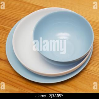 Top view of various plates on a wooden table Stock Photo