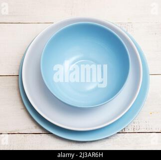 Top view of various plates on a wooden table Stock Photo