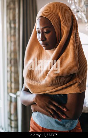 Tranquil portrait of beautiful young black muslim woman wearing hijab Stock Photo