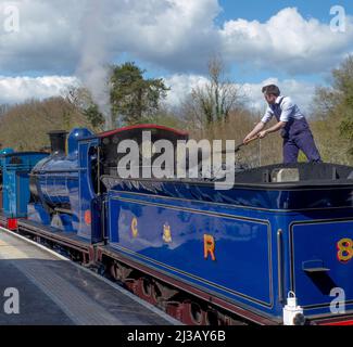 The fireman shovels coal forward on Caledonian Railway Class 812 0-6-0 No 828. At Eridge Station on the Spa Valley Railway. Stock Photo