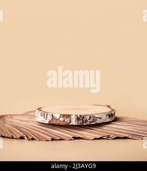 Product pedestal. Wooden cylinder podium on beige background. Blank natural shelf for goods display. High quality photo Stock Photo