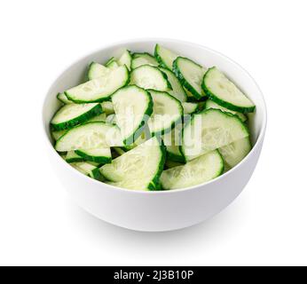 Cucumbers cut into pieces in a bowl, isolated on a white background. Side view. Stock Photo