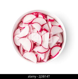 Radish cut into pieces in a bowl is isolated on a white background. Top view Stock Photo