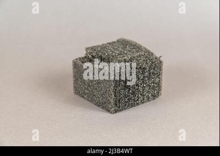 A piece of black foam against a gray background. Material that is used to protect the parcel seal. Stock Photo
