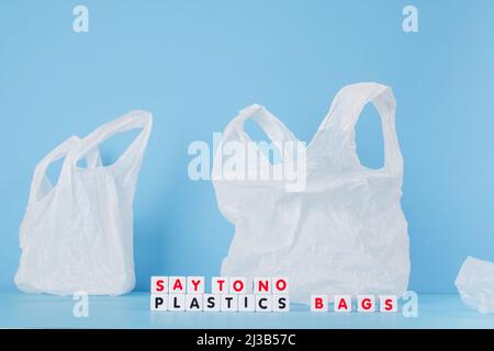 Say to no plastics bags words from cubes on the background of a white plastic bag. Plastic free concept. High quality photo Stock Photo