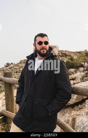 A portrait of an adult Caucasian man standing in El Torcal de Antequera during daytime, Malaga, Spain Stock Photo