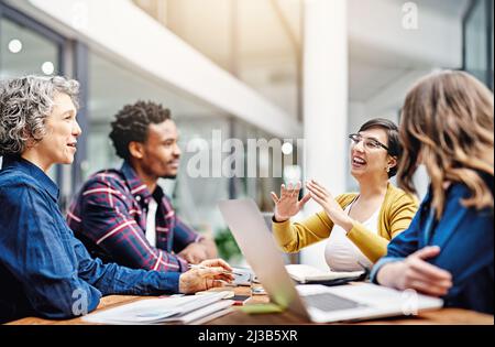 They produce the most dynamic work together. Cropped shot of a group of creatives having a meeting in a modern office. Stock Photo